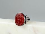 an image of a ring with a red stone in the middle