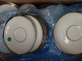 two white plates in a box with a green button