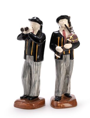 two figurines of two men playing musical instruments