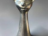 an image of a silver cat head vase on a white surface