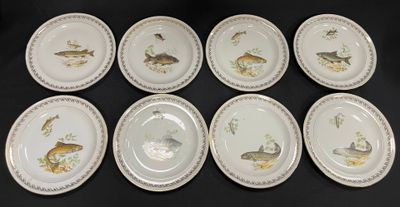 six plates with different designs of fish on them on a black surface