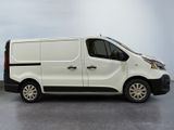 the white van is parked on the concrete floor in the room