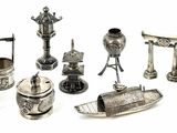 a lot of silver items that are on a white surface