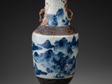 a blue and white vase with a mountain scene on it