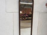 a mirror that is sitting on a wall in a room