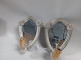 two mirrors that are sitting on a white table