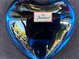 a blue glass heart shaped object with a picture on it