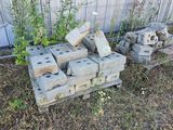 a pile of bricks sitting in the grass next to a fence