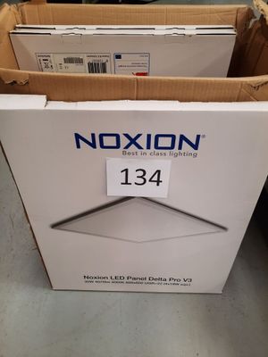 the box is open on the floor next to two boxes of electronic equipment