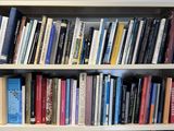 a bookshelf with many books on it in a room