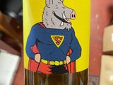 a bottle of wine with a picture of a pig on it