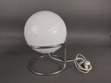 a lamp that is sitting on a stand on a table