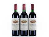 three bottles of red wine sitting next to each other on a white surface