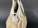 a close up of a white purse on a black surface
