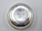 an antique silver plate with a silver lid sitting on a white surface