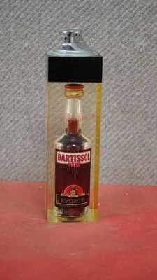 a bottle of artissol sitting on a red surface