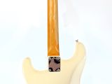 an image of a white electric guitar on a stand on a white background
