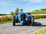 a blue car that is driving down the road