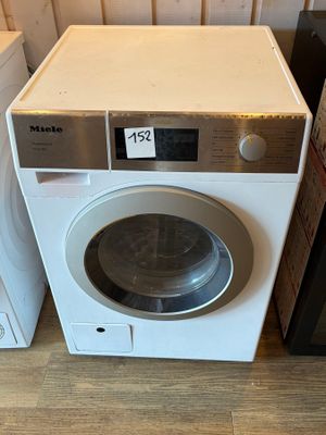 a washing machine sitting next to a dryer on the floor