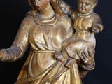 bronze statue of a woman holding a baby and a child