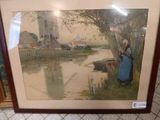 framed picture of a woman standing by a river with a windmill in the background