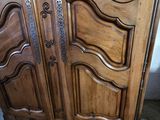 a large wooden cabinet with a door on top of it
