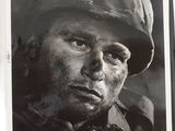 an old black and white photo of a man wearing a hat