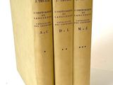 three books sitting on top of each other on a white surface
