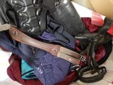 a pile of clothes and a pair of shoes in a suitcase