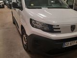 the white van is parked in a garage with other cars