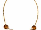 an image of a necklace with orange stones on it