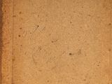 an old book with writing on it sitting on a table