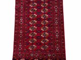 a red rug with a medallion design and fringes