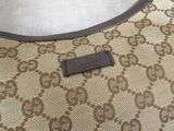 beige and brown guccissi bag with brown leather trim