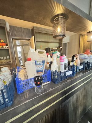de nombreuses bouteilles de produits d'entretien sur le comptoir d'un restaurant