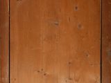 an old wooden door with a small window in it