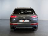 the rear view of a grey car in a showroom