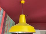 a yellow light hanging from the ceiling in a room
