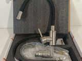 a box with a faucet and a hose in it