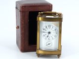 a small clock that is sitting inside of a box