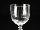a wine glass sitting on a table with a black background