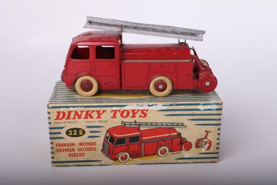 a red toy truck with a ladder on top of it