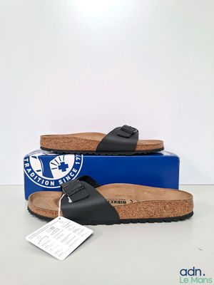 black birkett sandals with cork soles and a blue box