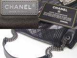 a black purse with a tag attached to it