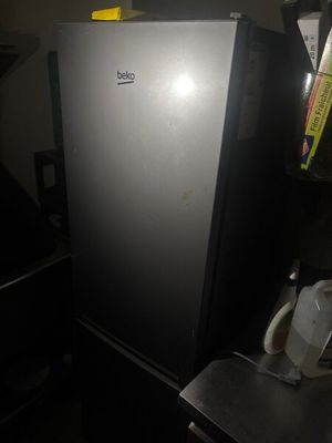 a refrigerator that is sitting in the corner of a room