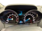 a close up of a car dashboard with a speedometer and gauges