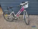 a bicycle that is parked in front of a garage