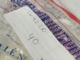a person holding a piece of paper that has been wrapped in plastic