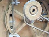 a close up of a clock with a metal mechanism
