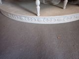 a white table with a clock on top of it